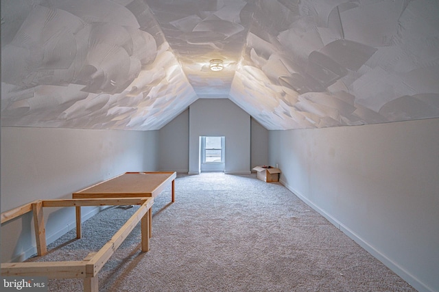 bonus room featuring carpet flooring and vaulted ceiling