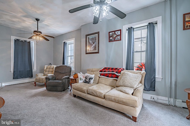 carpeted living room with ceiling fan, a healthy amount of sunlight, and a baseboard heating unit