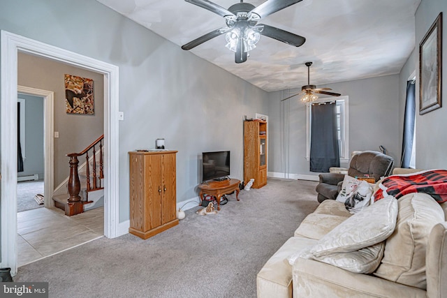 carpeted living room with ceiling fan and baseboard heating