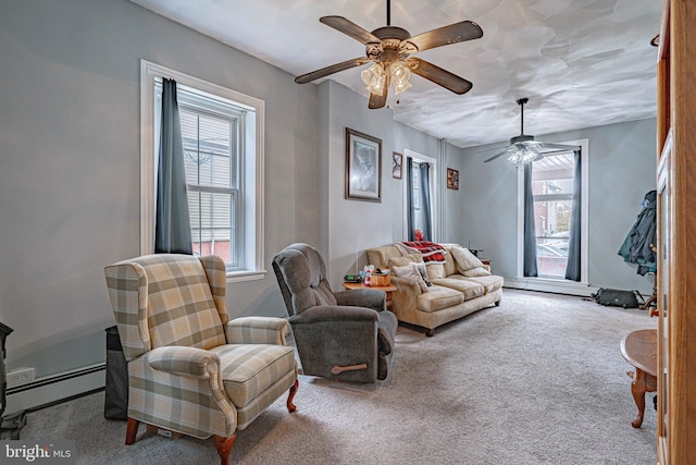 carpeted living room with ceiling fan and a baseboard heating unit