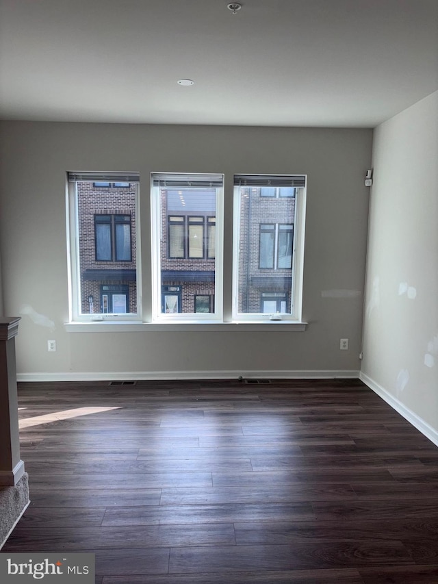 empty room with dark hardwood / wood-style floors