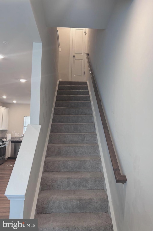 staircase with hardwood / wood-style flooring