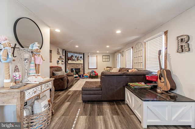 living room with dark hardwood / wood-style floors and a tiled fireplace