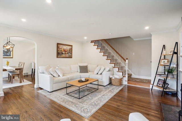 living room featuring ornamental molding and dark wood-type flooring