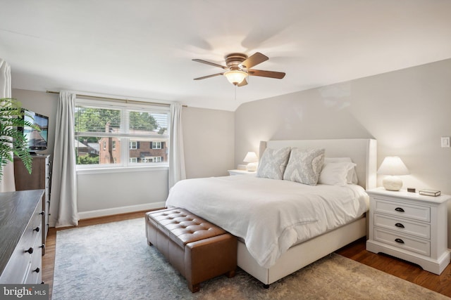 bedroom featuring ceiling fan and dark wood-type flooring