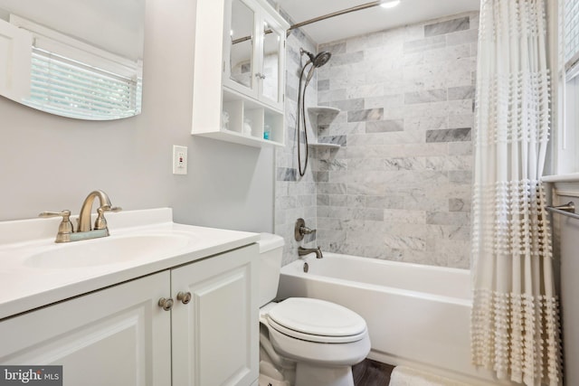 full bathroom featuring shower / tub combo with curtain, vanity, and toilet