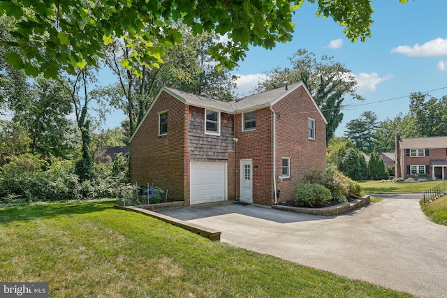 view of side of home featuring a yard and a garage