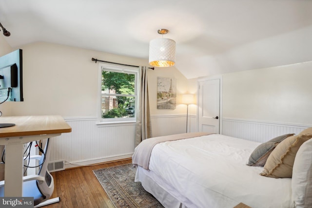 bedroom with dark hardwood / wood-style flooring and vaulted ceiling