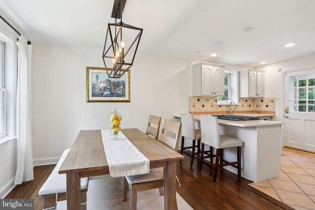 dining area featuring an inviting chandelier and light hardwood / wood-style flooring