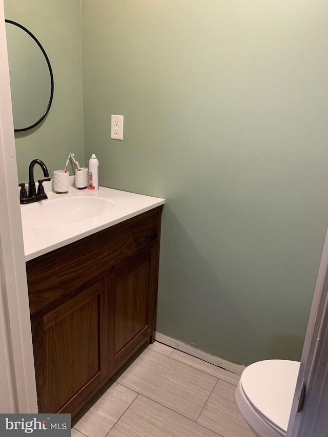 bathroom featuring vanity and toilet