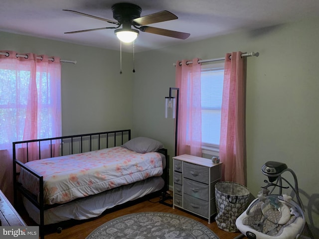 bedroom with ceiling fan and hardwood / wood-style floors