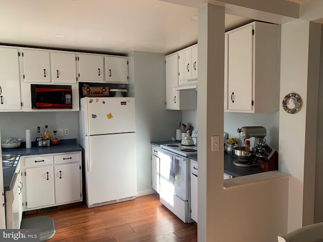 kitchen with white appliances, light hardwood / wood-style flooring, and white cabinets