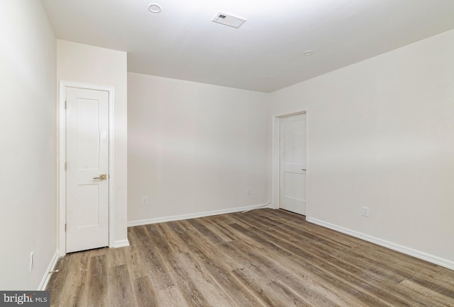 unfurnished room featuring hardwood / wood-style flooring