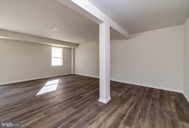 basement with dark hardwood / wood-style floors