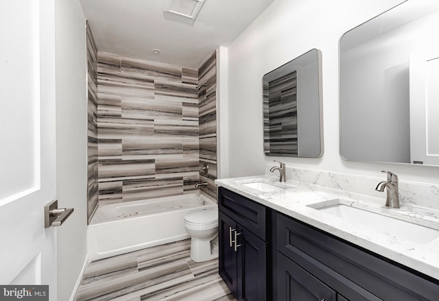 full bathroom with hardwood / wood-style floors, vanity, toilet, and tiled shower / bath combo