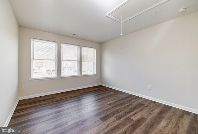 spare room with dark hardwood / wood-style flooring