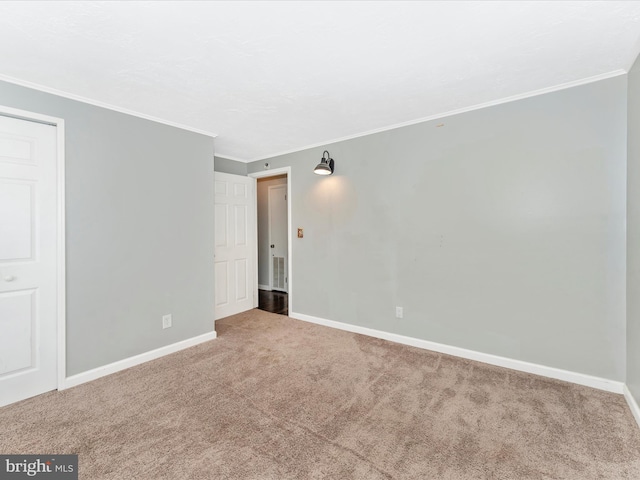 spare room featuring carpet flooring and crown molding