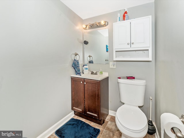 bathroom with tile patterned floors, vanity, and toilet