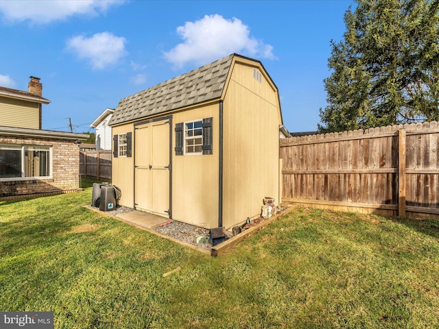 view of outbuilding featuring a lawn