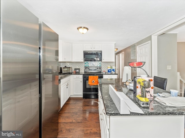 kitchen featuring dark hardwood / wood-style floors, dark stone counters, decorative backsplash, white cabinets, and black appliances