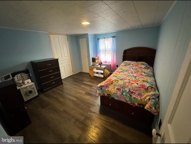 bedroom with dark hardwood / wood-style flooring