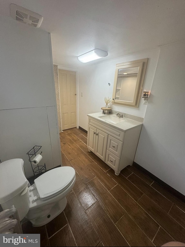 bathroom featuring hardwood / wood-style floors, vanity, and toilet