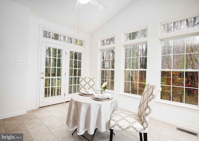 sunroom / solarium with a wealth of natural light, lofted ceiling, and ceiling fan