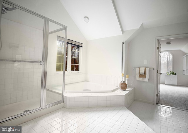 bathroom with separate shower and tub, tile patterned flooring, and lofted ceiling