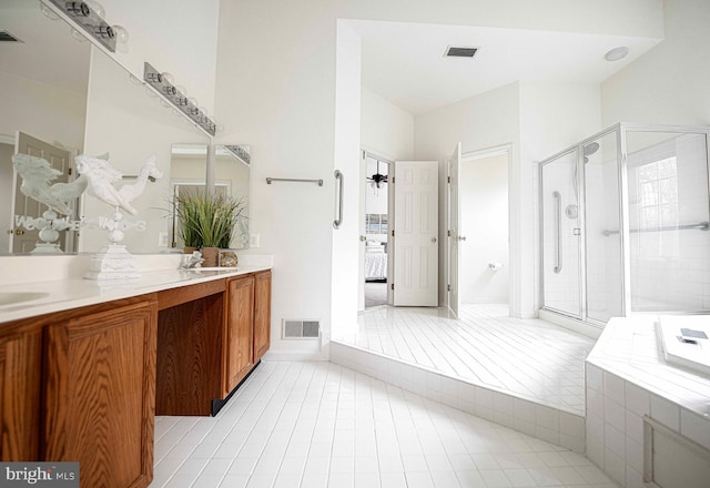 bathroom with tile patterned flooring, vanity, and independent shower and bath