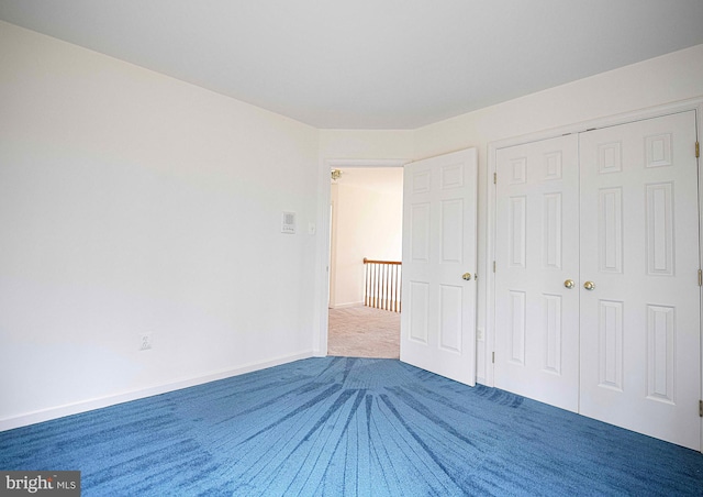 unfurnished bedroom with carpet flooring and a closet