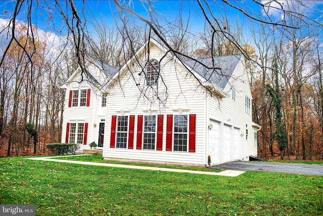 view of front of property featuring a garage and a front yard