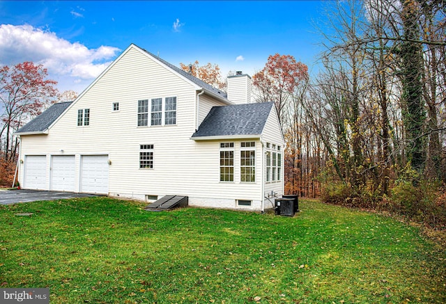 back of house with a yard and central air condition unit