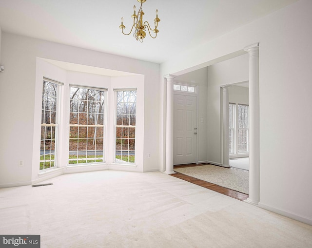 entryway featuring hardwood / wood-style flooring, plenty of natural light, and a notable chandelier