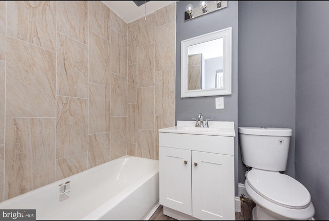 full bathroom with tiled shower / bath, vanity, and toilet