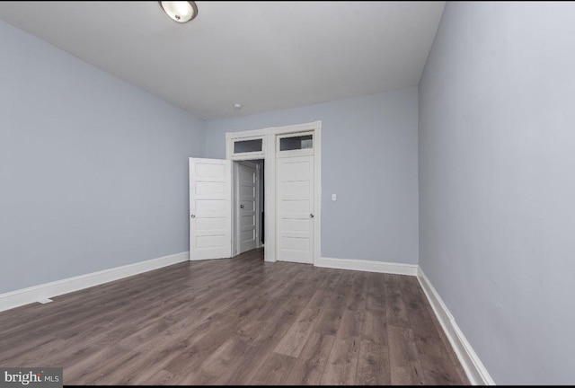 unfurnished bedroom featuring dark hardwood / wood-style floors and a closet