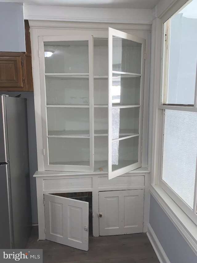 interior space with stainless steel refrigerator and dark hardwood / wood-style floors