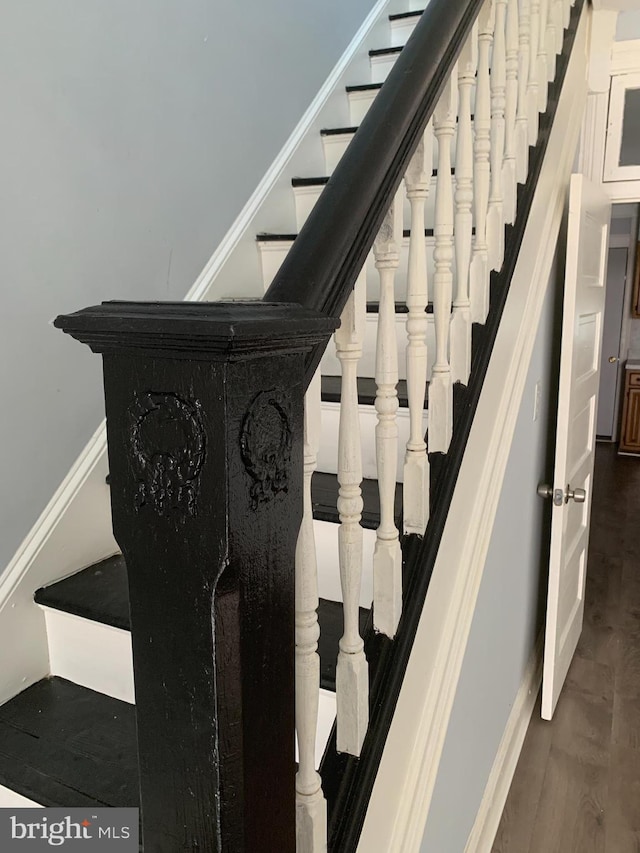 stairway featuring hardwood / wood-style flooring