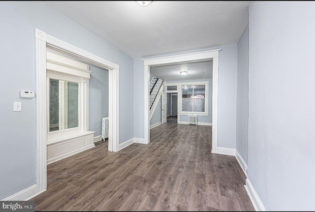 corridor featuring dark hardwood / wood-style floors and radiator