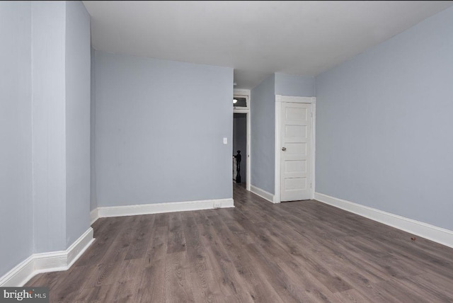 spare room with dark hardwood / wood-style flooring