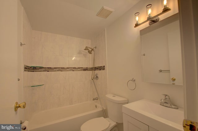 full bathroom with vanity, toilet, and tiled shower / bath