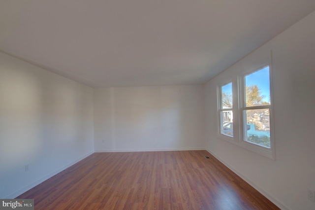 unfurnished room featuring dark hardwood / wood-style flooring