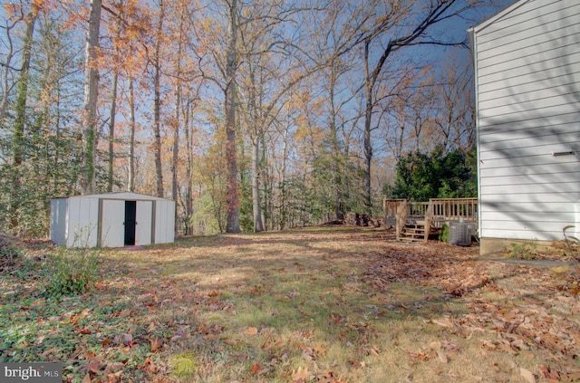 view of yard with a shed and a deck