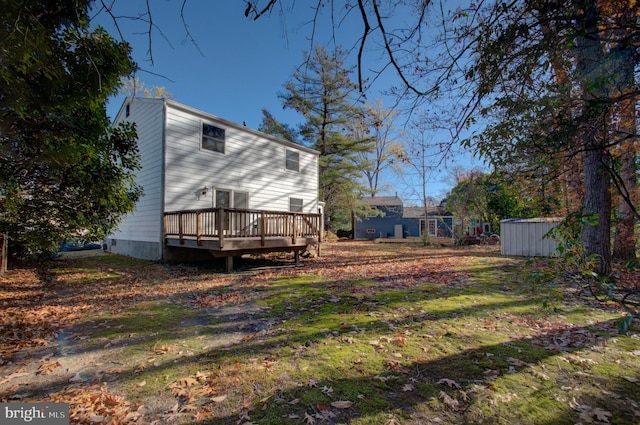 view of yard with a storage shed and a deck