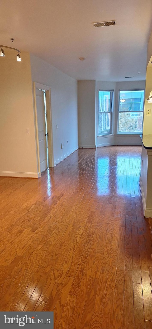 unfurnished room with hardwood / wood-style flooring