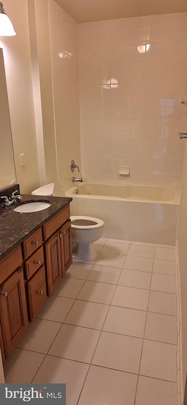 full bathroom with tile patterned flooring, vanity, toilet, and tiled shower / bath combo