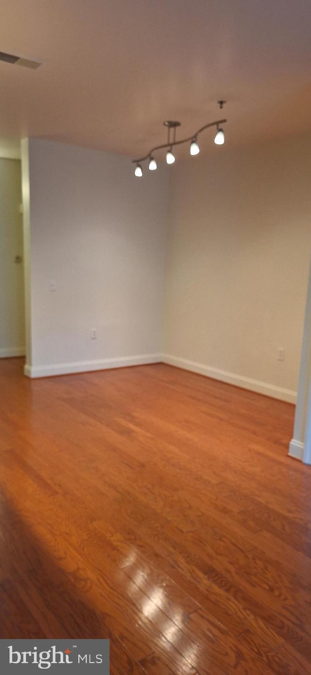 spare room with hardwood / wood-style floors