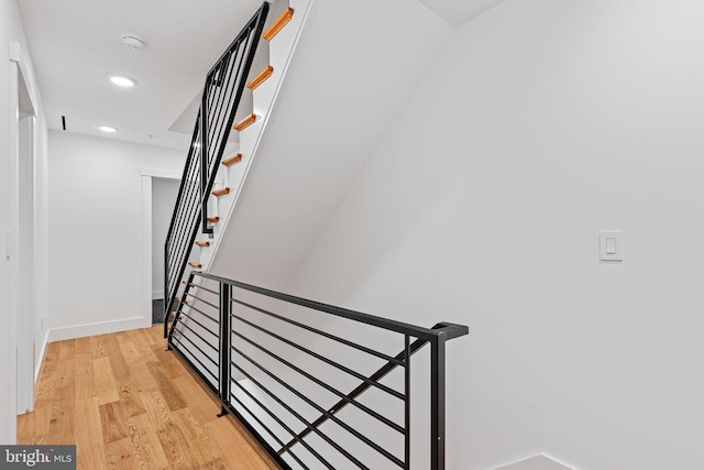 stairs featuring hardwood / wood-style flooring