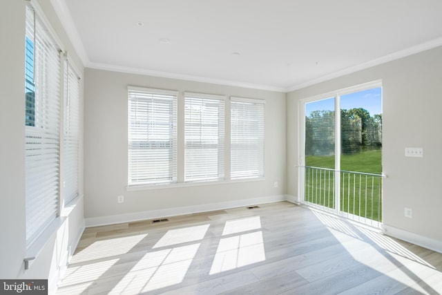 interior space with light wood-type flooring and crown molding