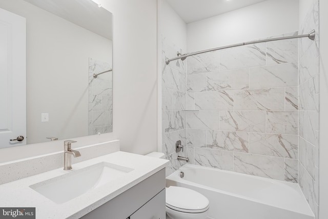 full bathroom with toilet, vanity, and tiled shower / bath