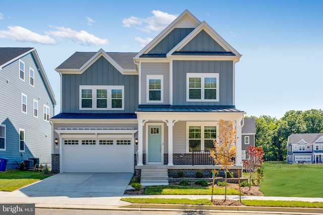 craftsman-style home featuring a front yard, central AC unit, a porch, and a garage